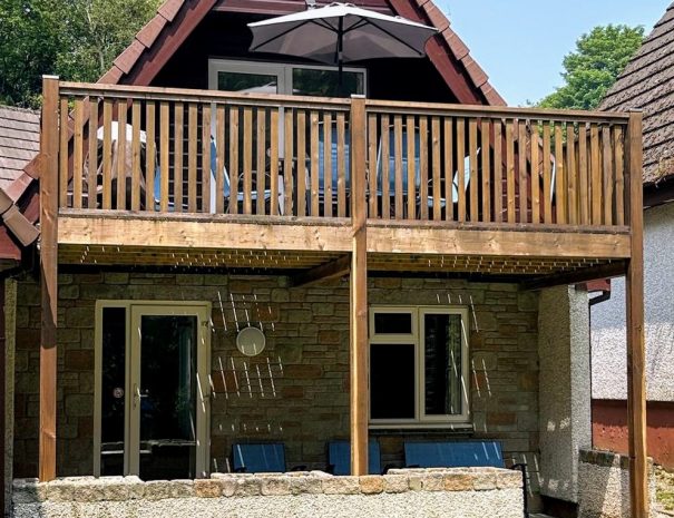 Front of lodge with balcony and patio area