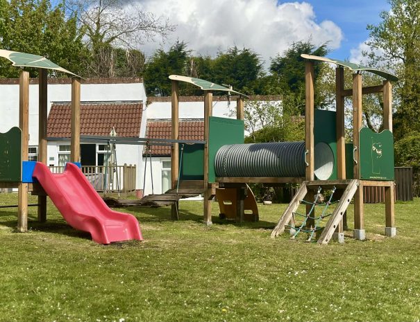 Outdoor play area, with climbing frame and slide